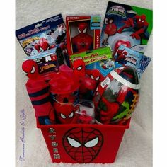 a red basket filled with toys on top of a white blanket