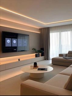 a living room filled with furniture and a flat screen tv mounted to the side of a wall