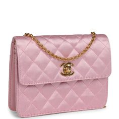 This Vintage mini flap bag is in Pink satin with gold hardware, featuring a single straight front flap with signature CC logo turnlock, a rear slip pocket, and a gold chain link shoulder/crossbody strap.The interior is lined in gold leather and includes one slip pocket on the back wall. Collection: 2-series (1991-1994) Origin: FranceCondition: Vintage; Excellent - This bag retains its shape and structure. There are some signs of wear to the exterior, including dirt marks, light staining, and mod Luxury Pink Shoulder Bag As A Gift, Luxury Light Shoulder Bag With Branded Hardware, Luxury Gift Pouch Flap Bag, Designer Blush Luxury Bags, Luxury Pink Shoulder Bag With Branded Hardware, Luxury Pink Bag With Logo Hardware, Chanel Mini Flap Bag, Chanel Mini, Cc Logo