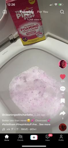 the toilet is full of pink foam on it