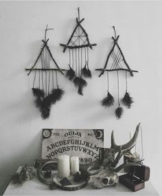 a table topped with feathers and candles on top of it