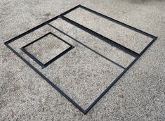 three square metal frames sitting on the ground