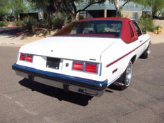 a white and red car parked in a parking lot