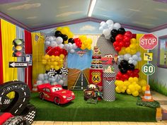 a birthday party with cars and balloons