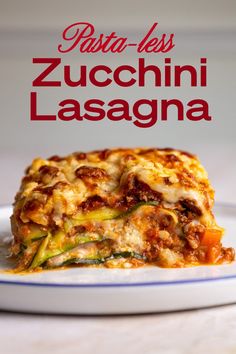 a white plate topped with lasagna covered in cheese