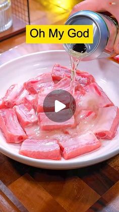 someone is pouring water into a bowl filled with raw meat