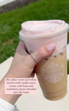 a woman's hand holding up a cup of coffee with the caption, my order went iced white when we were cream cold foam and strawberry pure blended into the foam