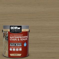 a can of behr premium waterproofing stain and sealer on a black background