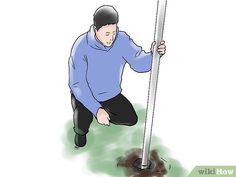 a man squatting on the ground with a pole in front of him and holding onto it