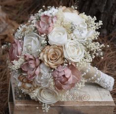 a bridal bouquet sitting on top of a wooden box