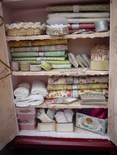 a shelf filled with lots of different types of fabric