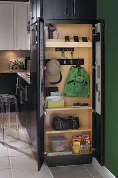 an open cabinet with several items in it and some lights on the wall behind it