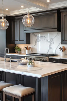 a kitchen with marble counter tops and dark wood cabinets, lights hanging from the ceiling