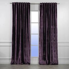 an open window with purple curtains in front of it