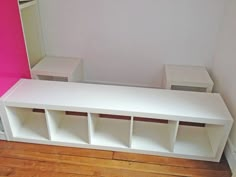 a white bench and some shelves in a room