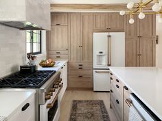 a kitchen with wooden cabinets and white appliances