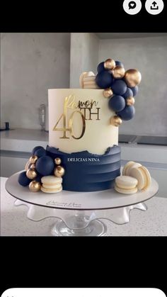 a blue and white cake with gold decorations on the top that says happy fortyth birthday