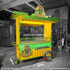 a yellow and green food cart sitting inside of a building