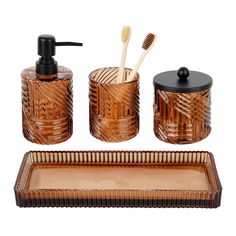 an assortment of bathroom accessories including soap dispenser, toothbrush holder and tray