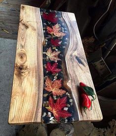 a piece of wood that has been made to look like leaves and berries on it