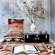 an open book sitting on top of a bed next to pillows