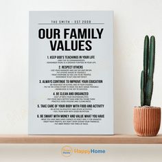 a poster on a shelf next to a cactus and a potted plant with the words our family values