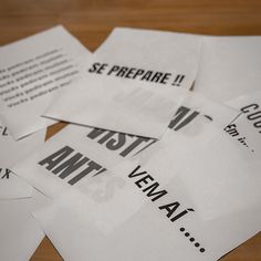 several pieces of paper that have been placed on top of each other with black and white lettering