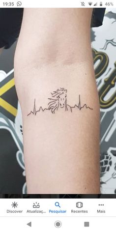 a woman's arm with a horse and heartbeat tattoo on the left side of her right arm