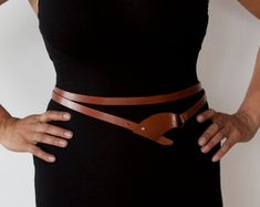 This double wrap brown belt is designed to be configured in a variety of ways, allowing you to perfectly accent your outfit every time.Made with high quality cowhide leather, 1/2" wide. Adjustable sizing, featuring a metal post closure.Available in 4 sizes: XS (fits waist 26-28”), S(fits waist 28-30”), M (fits waist 30-32”), L(fits waist 32-34”)Please check our shop for other colour options:https://www.etsy.com/shop/Rimanchik/search?search_query=chica&order=date_desc&view_type=gallery&am Double Wrap Belt, Corset Belts, Leather Wrap Belt, Casual Leather Belt, Handmade Belt, Tan Leather Belt, Metal Post, Handmade Leather Belt, Leather Jewellery