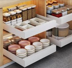 an organized kitchen drawer with plates and bowls