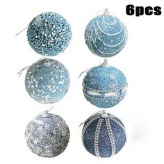 six blue and silver christmas ornaments hanging from strings