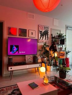 a living room filled with furniture and a large flat screen tv mounted on the wall