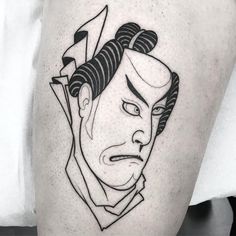 a black and white tattoo of a man's face with scissors in his hair