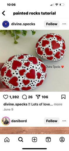 two red and white painted rocks sitting on top of a table