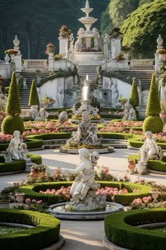 an elaborate garden with statues and flowers in the center is surrounded by hedges, trees, and bushes