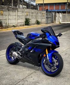 a blue and black motorcycle parked on the street