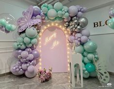 an arch made out of balloons and other decorations