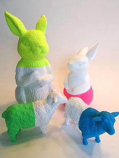 three small plastic animals standing next to each other