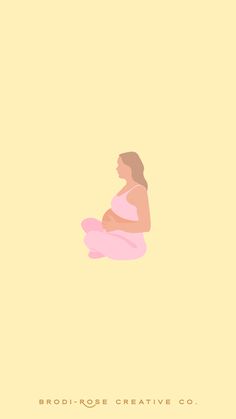 a pregnant woman sitting on the floor with her legs crossed in front of her belly