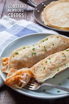 two burritos on a plate with a fork