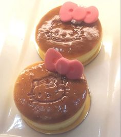 two hello kitty cookies with chocolate frosting on them