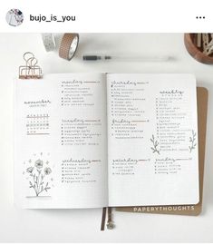 an open planner book sitting on top of a desk