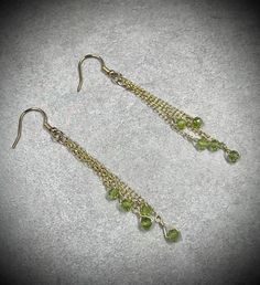 These gold peridot earrings feature 10 3mm peridot beads in 14k gold filled wire and chain.  These August birthstone earrings are genuine peridot gemstones, non-tarnish, and perfect for any occasion.  About the Earrings: - Non-tarnish 14k gold filled wire, chain, and ear wires - Genuine peridot - Handmade - Safe for daily wear - Suitable for those with metal allergies or sensitivities THESE EARRINGS ARE MADE TO ORDER Please allow an additional 1-3 days for handmade creation of your jewelry.  Made-to-order pieces are made with gemstones of the same size, shape, color, and quality as the original in the photos.  As these are natural gemstones, there may be some slight variation in color and/or color pattern. Return policy: - Our work is guaranteed!  We offer repair services as well as interm Birthday Gifts For Wife, Wire Wrapped Gemstone Jewelry, Ethiopian Opal Jewelry, Sterling Silver Opal Ring, Morganite Earrings, Oxidised Silver Jewelry, Energy Jewelry, Dangle Earrings Gold, Jewelry Delicate