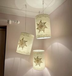 three lamps hanging from the ceiling in a room