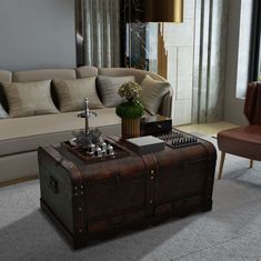 a living room with a couch, coffee table and trunk on the floor in front of it