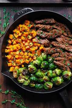 steak, brussel sprouts and sweet potatoes in a cast iron skillet