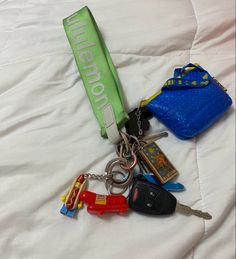 several keys are laid out on a bed with a name tag and lanyard attached to it