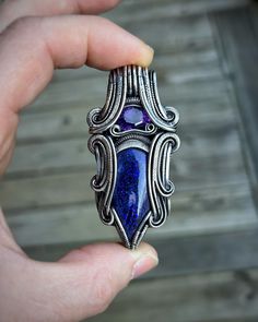 * Faceted Amethyst * Australian Opal cabochon * Oxidized/Polished Sterling Silver Dimensions: 6.5cm x 3.2cm #purple #purplependant #amethyst #amethystjewelry #amethystpendant #purpleopal #symmetry #symmetrical #symmetricaljewelry #wirewrap #wirewrapping #wirewrappedjewelry #wirewrappedcrystals #wrapsofinstagram #wirewrapsofig #wirewrappedpendant #festivaljewelry #oxidizedsilver #pendantsofinstagram #pendantsofig #oxidizedsilverjewelry #riojeweler #pendant #handmade #oneofakind #handmadejewelry #innerorbitjewelry #innerorbit Unique Purple Gemstones For Jewelry Making, Handmade Pendant Gemstones For Formal Occasions, Luxury Handmade Purple Jewelry, Artistic Handmade Purple Jewelry, Unique Handmade Purple Gemstones, Handmade Blue Amethyst Gemstones, Spiritual Purple Wire Wrapped Jewelry, Handmade Artisan Amethyst Gemstones, Luxury Handmade Lapis Lazuli Jewelry