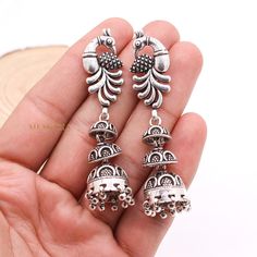 Peacock Silver Dangle Earring, Jhumka Silver Earring, Oxidized Dangle Drop Earring, 925 Sterling Silver Earring, Cyber Monday Sale ✦ ✦ METAL DETAILS✦ ✦  ✦ Metal : 925 Sterling Silver ✦ Earring Size : 68X15 mm  ✦ Total Weight : 28.52 Gram  ✦ Earring Box : Yes ✦ CUSTOMISATION DETAILS✦ We can customize any piece of fine jewelry. You can simply message us on Etsy or drop a text at +91-7357229656 (WhatsApp/I Message) to let us know about all the customization you want. Customization can include : ✦ Metal Type: 9K Gold, 10K Gold, 14K Gold, 18K Gold, 22K Gold, 925 Sterling Silver (All designs) ✦ Any Other Request: Your dream it appears can make it! Let us know about any request you have and we will get it done for you! ✦ Have your own custom design? Send us a message and we will make it for you e Elegant Sterling Silver Earrings With Peacock Design, Silver Peacock Design Drop Earrings, Sterling Silver Dangle Jewelry With Latkans, Sterling Silver Earrings With Latkans For Gift, Fusion Style Sterling Silver Danglers, Silver Earrings With Peacock Design As A Gift, Silver Dangle Jewelry With Peacock Design, Silver Peacock Design Earrings Gift, Gift Silver Earrings With Peacock Design