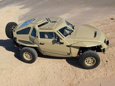 an off - road vehicle is parked in the desert